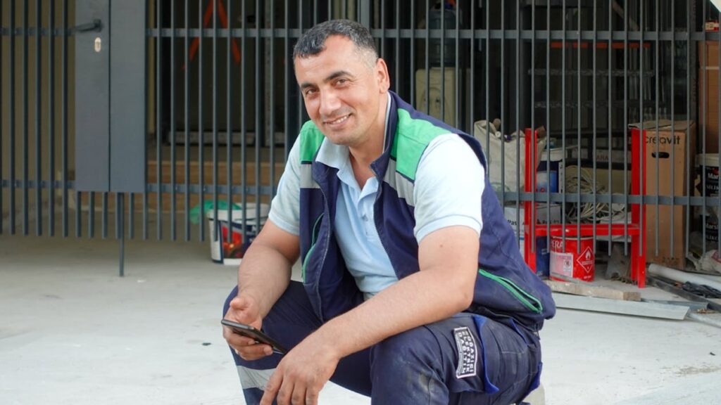 Construction worker using smartphone on jobsite - fast contractor estimates with InstaBid